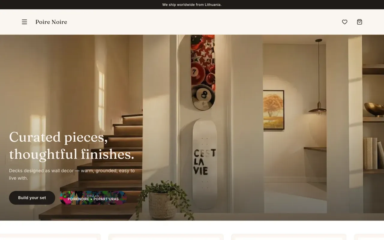 Poire Noire homepage hero showing a warm modern interior with skateboard decks mounted on a wall and the headline Curated pieces, thoughtful finishes.